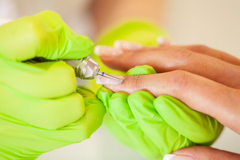 Manicure. Skillful Master of Manicure Holding File in Her Hands while Working in Her Beauty