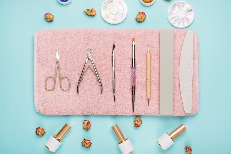 Manicure Tools on a Pink Towel and a Blue Background. Manicure