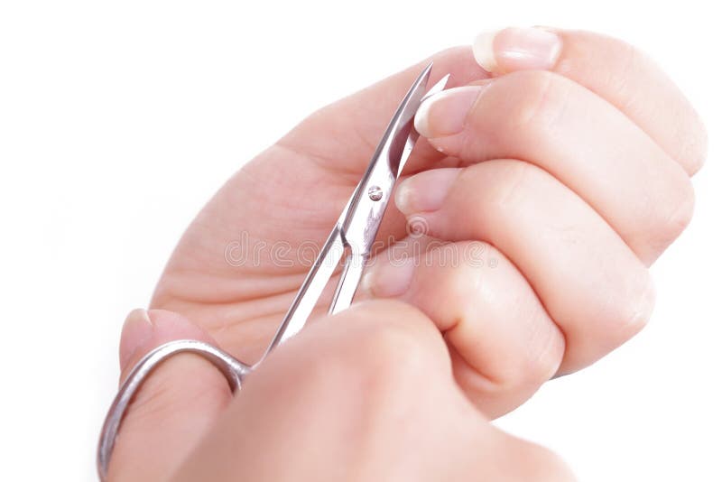 manicure - woman hands with nail scissors to cut nails