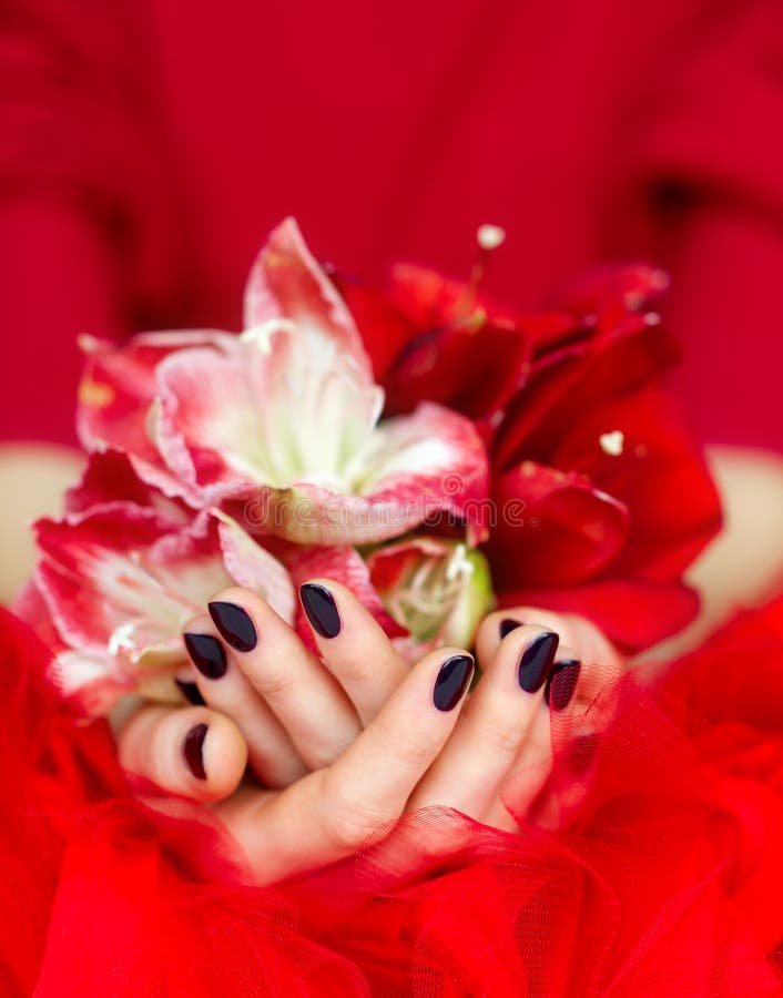 Manicured cupped hands holding flowers