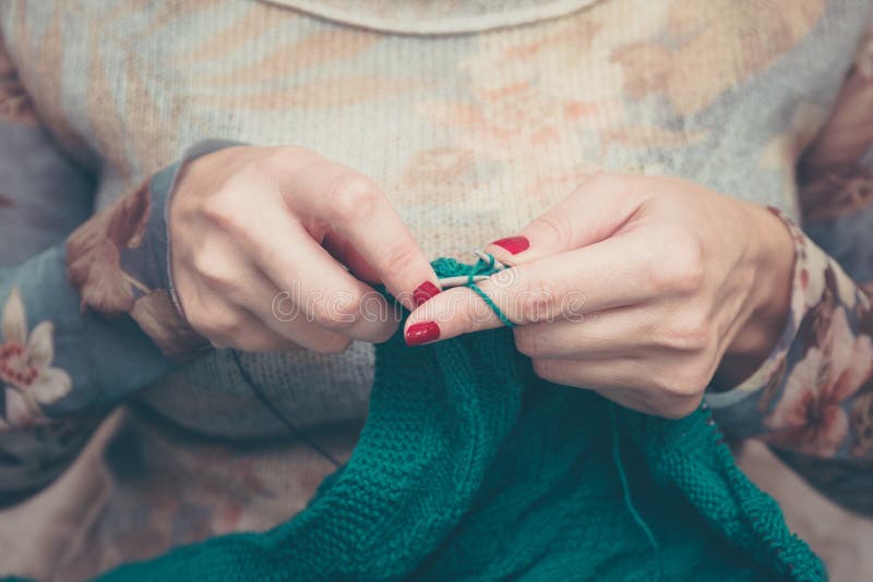 Manicured woman hands knitting green plaid royalty free stock image Manicured woman hands knitting green plaid royalty free stock image