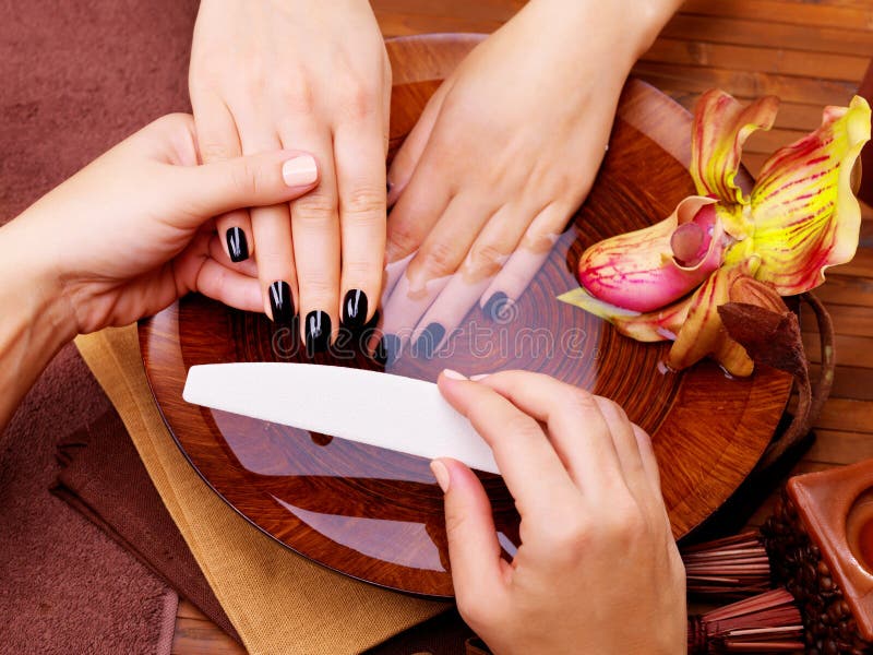 Manicurist master makes manicure on woman's hands stock images Manicurist master makes manicure on woman's hands stock images