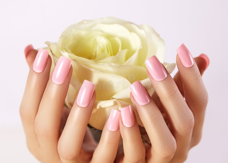 Manicured nails with pink nail polish. Manicure with nailpolish. Fashion art manicure with shiny gel lacquer. Nails salon. Manicured nails with pink nail polish. Manicure with nailpolish. Fashion art manicure with shiny gel lacquer. Nails salon