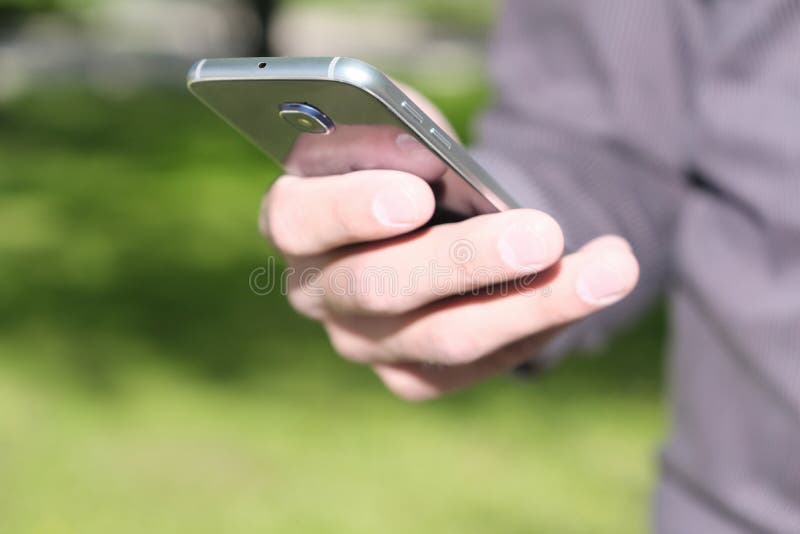 Manlig hand som rymmer en mobiltelefon fotografering för bildbyråer Manlig hand som rymmer en mobiltelefon fotografering för bildbyråer