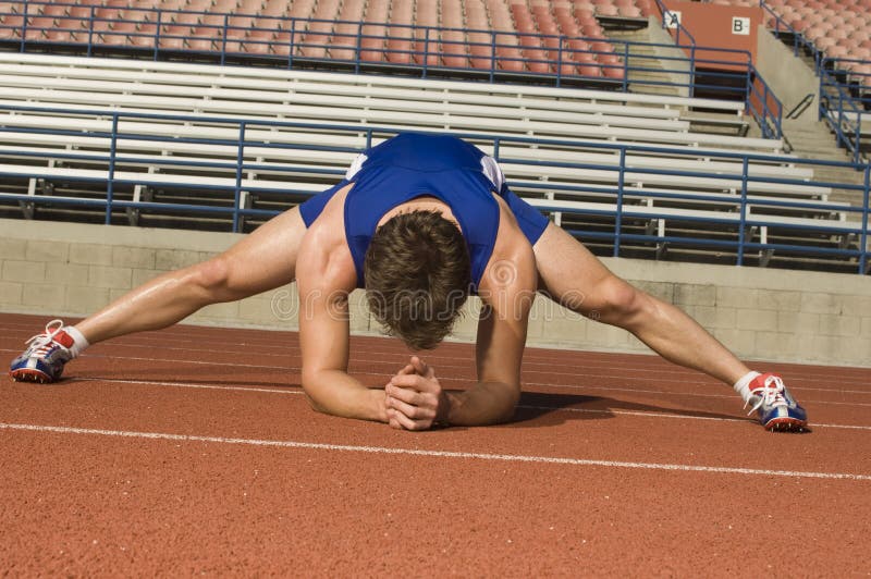 Manlig idrottsman nen Stretching In Stadium royaltyfria foton