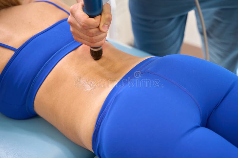 Male orthopedist using extracorporeal shock wave therapy like non-invasive option for treatment of various pains and diseases of the musculoskeletal system. Male orthopedist using extracorporeal shock wave therapy like non-invasive option for treatment of various pains and diseases of the musculoskeletal system