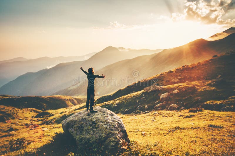 Man raised hands at sunset mountains Travel Lifestyle success and wellness emotional concept adventure vacations outdoor hiking harmony with nature aerial view. Man raised hands at sunset mountains Travel Lifestyle success and wellness emotional concept adventure vacations outdoor hiking harmony with nature aerial view