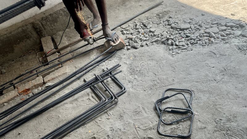 Male worker cutting out the lengthy steel bar -Image. Male worker cutting out the lengthy steel bar -Image