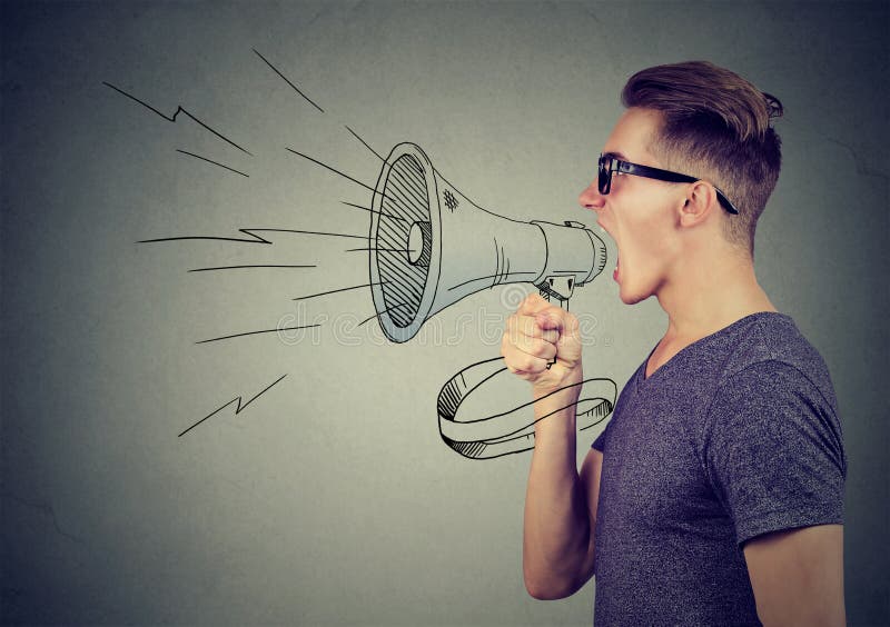 Young man screaming in a megaphone making announcement. Young man screaming in a megaphone making announcement