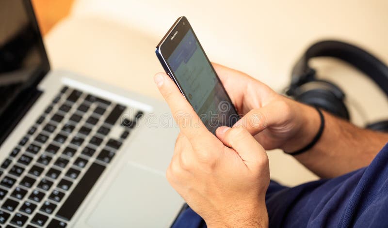 Mann, der sein intelligentes Telefon betrachtet stockfotografie Mann, der sein intelligentes Telefon betrachtet stockfotografie