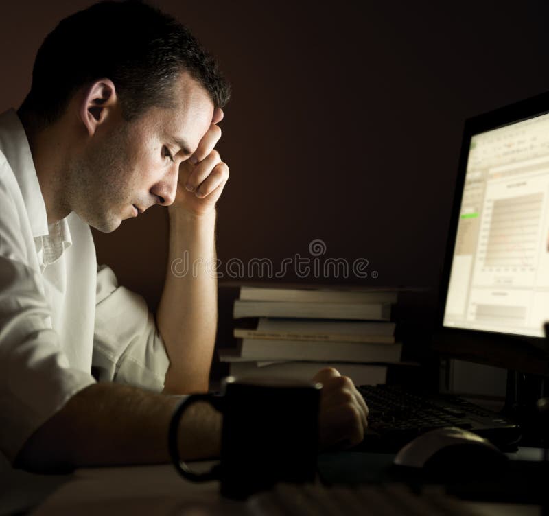 Man working late in front of a computer. Man working late in front of a computer