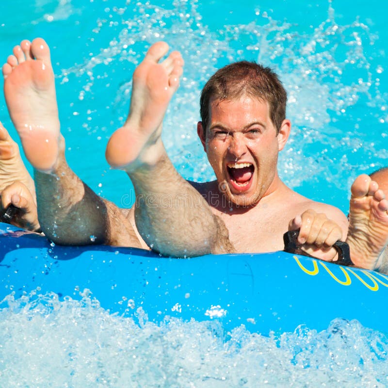 Man having fun, sliding at water park. Man having fun, sliding at water park.