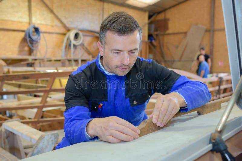 Mannen målar träobjekt från seminarium arkivbild Mannen målar träobjekt från seminarium arkivbild