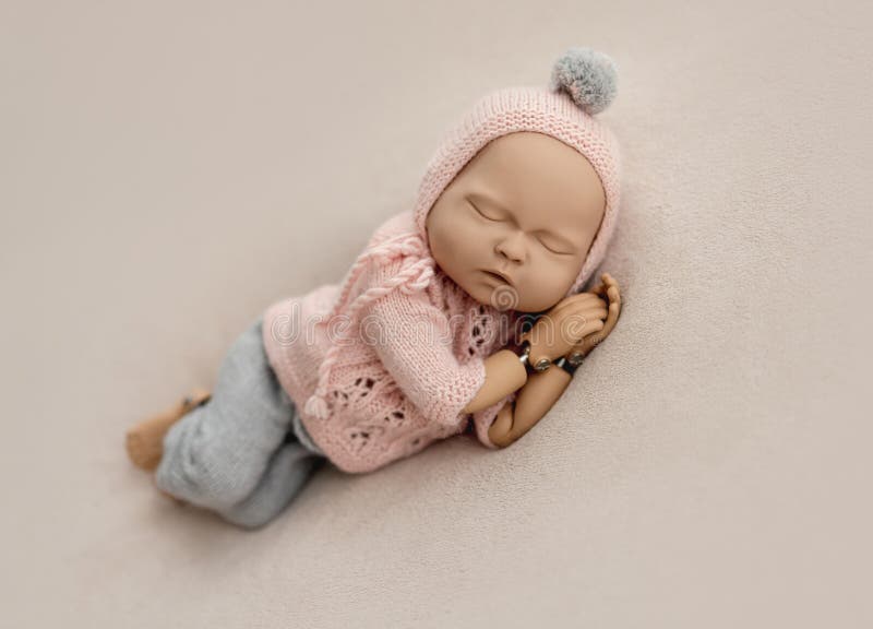 Precisely accurate mannequin of newborn in a knitted suit for photo practicing. Little marionette stock images, royalty-free photos and pictures