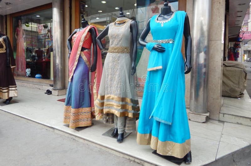 Mannequins in front of a clothes retail shop