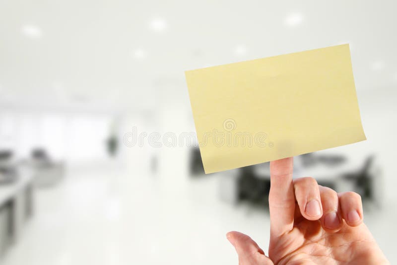 Hand with blank yellow sticky note on finger in the office. Hand with blank yellow sticky note on finger in the office