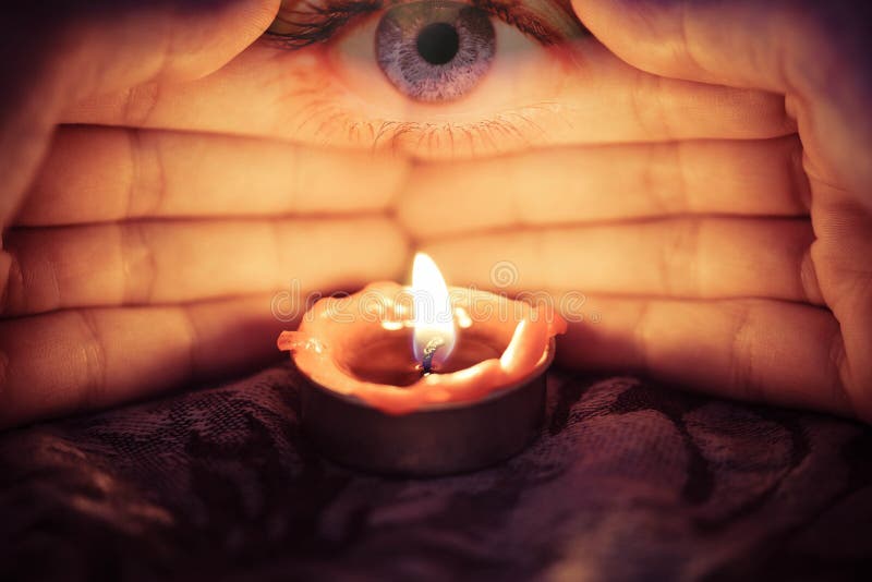 Hand with candlelight burning candle on the darkness background with the eye looking for Astrology Occult Magic illustration / Magic Spiritual Horoscopes and Palm reading fortune teller concept. Hand with candlelight burning candle on the darkness background with the eye looking for Astrology Occult Magic illustration / Magic Spiritual Horoscopes and Palm reading fortune teller concept