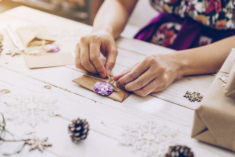 Woman hand making beautiful Christmas card at table. Woman hand making beautiful Christmas card at table.