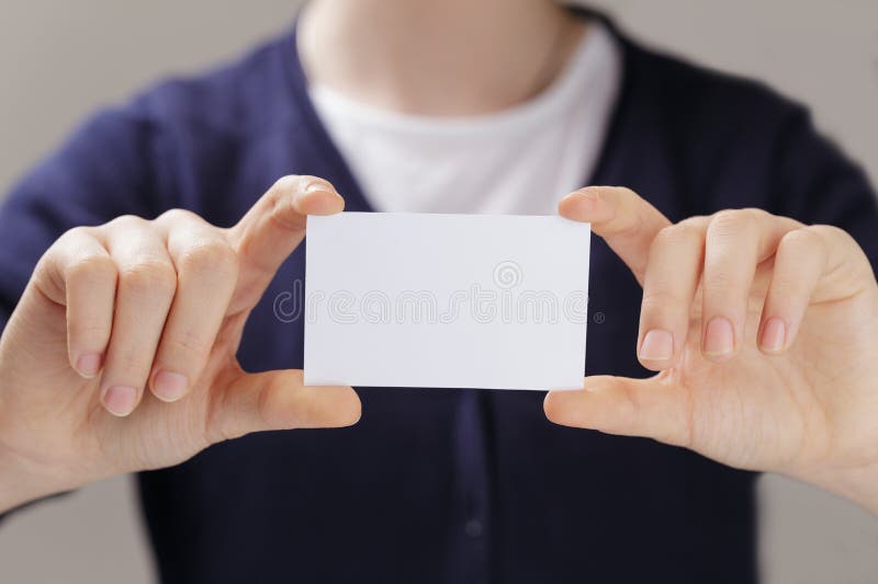 Manos adolescentes femeninas que sostienen la tarjeta de visita foto de archivo Manos adolescentes femeninas que sostienen la tarjeta de visita foto de archivo