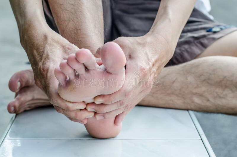 Man's hand being massaged a foot in the park. Man's hand being massaged a foot in the park