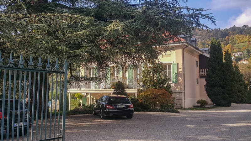 The mansion entrance gate house villa car parked under tree