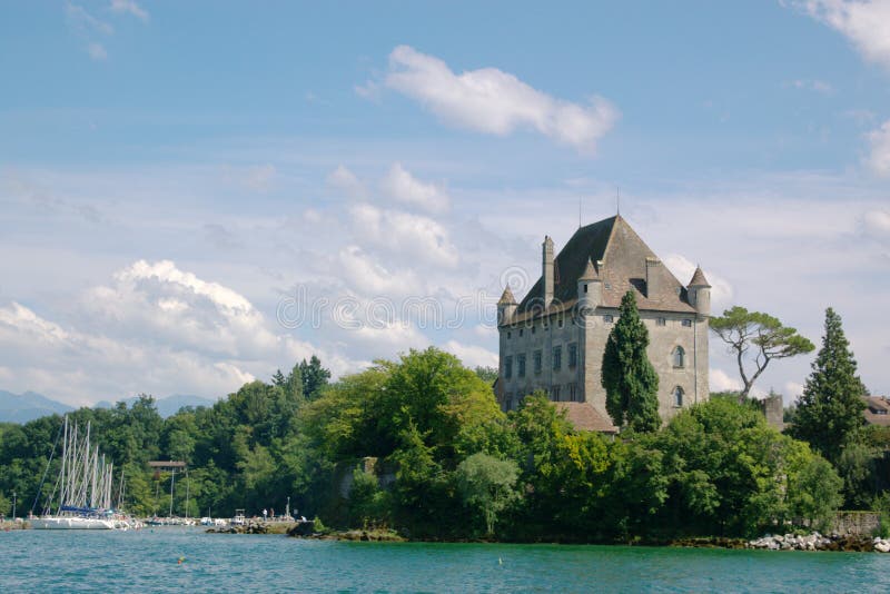 Authentic french mansion on lake shore, surrounded with trees and pier with docking yachts, horizontal. Authentic french mansion on lake shore, surrounded with trees and pier with docking yachts, horizontal.