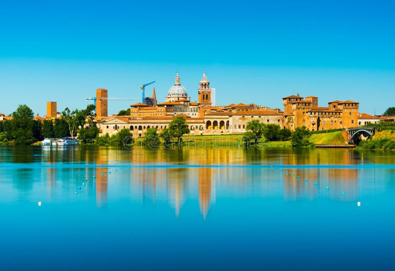 Mantova, Italia: Paesaggio urbano riflesso in acqua Vecchio orizzonte italiano della città fotografia stock Mantova, Italia: Paesaggio urbano riflesso in acqua Vecchio orizzonte italiano della città fotografia stock