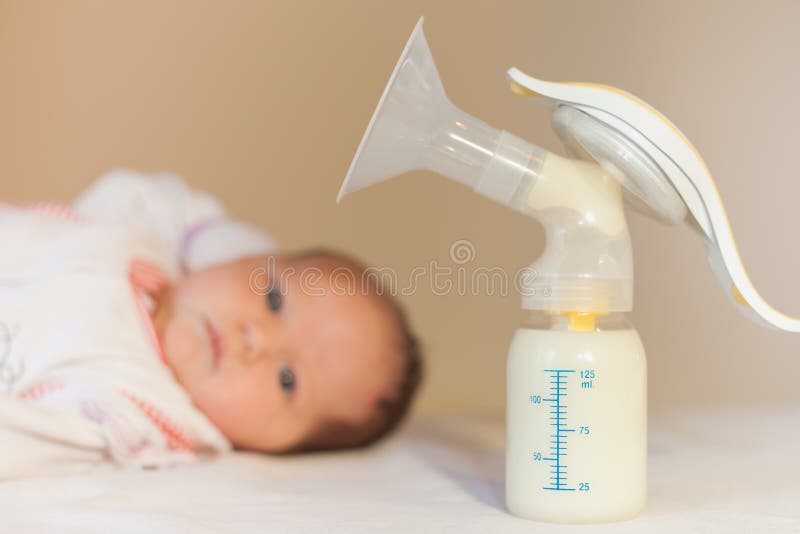 Manual breast pump and milk at background stock photo Manual breast pump and milk at background stock photo