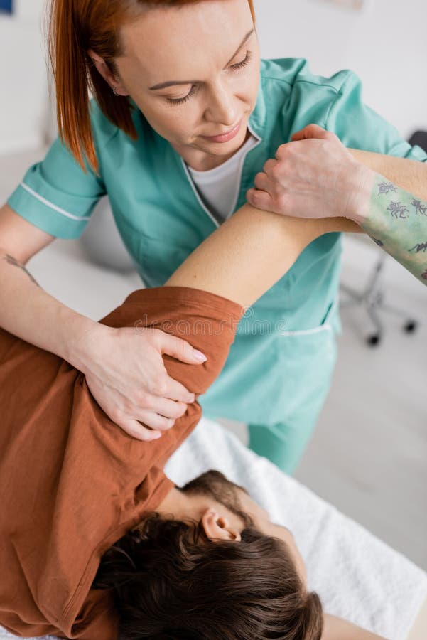 Manual Therapist Stretching Painful Arm of Stock Photo Image of care