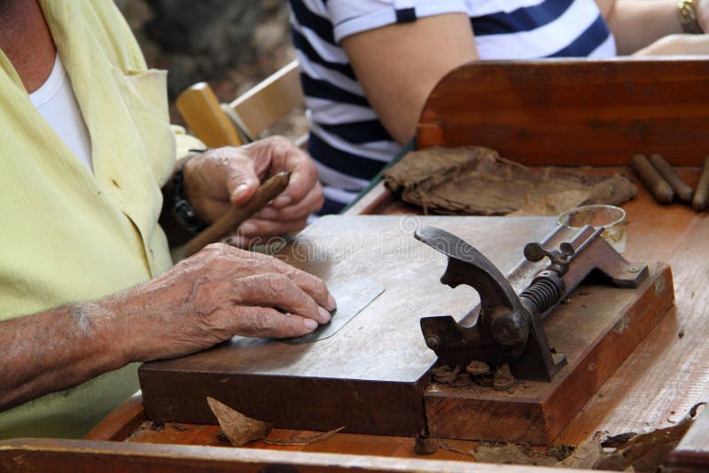 A man working on making the cigars. A man working on making the cigars