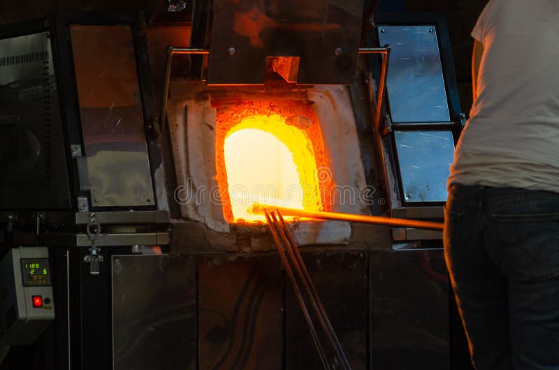 Manufacturing Glass in a Traditional Oven, the Glassblower Working on a