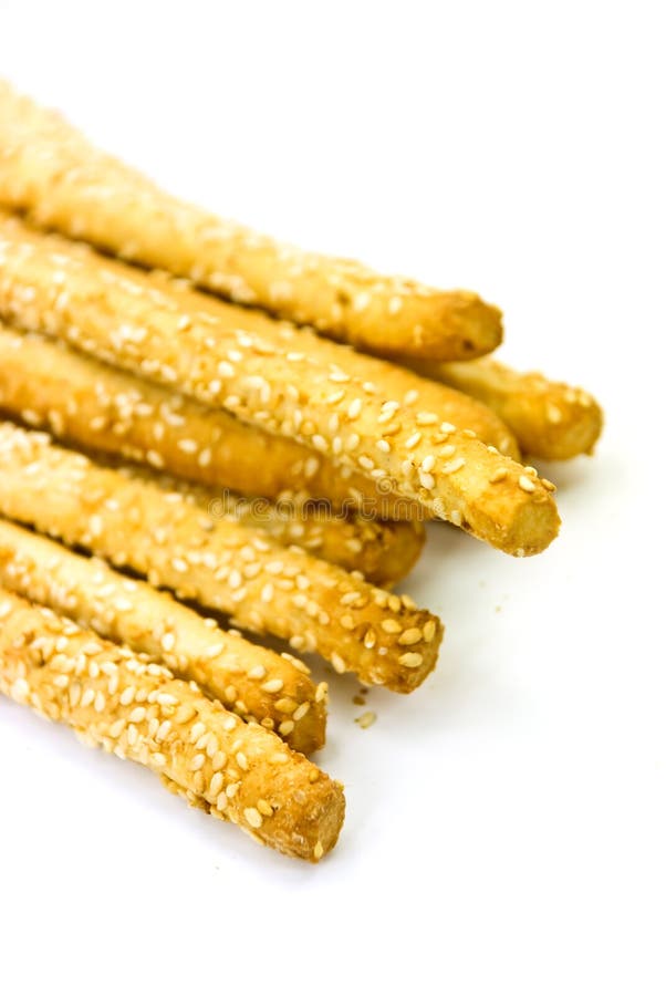 Many breadsticks with sesame - isolated on the whi