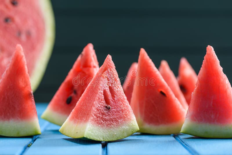 Many bright juicy watermelon slices cut into triangular shape. Summer refreshing snack closeup. Triangular cut watermelon stock images, royalty-free photos and pictures