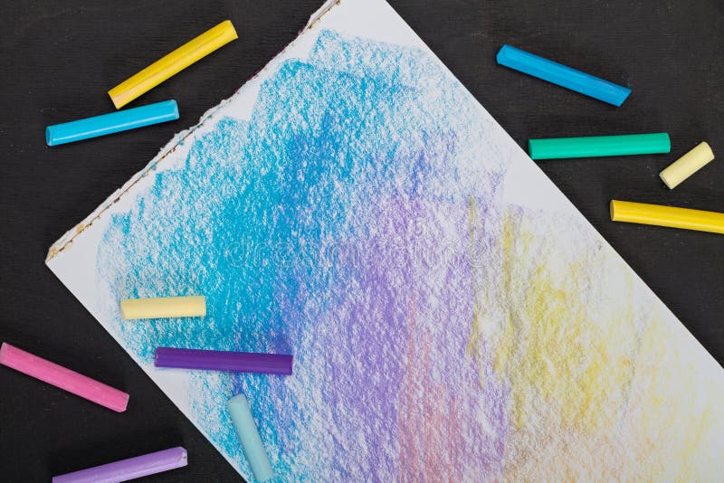 Colored Crayons Pastels and Colored Picture on a Dark Background Stock
