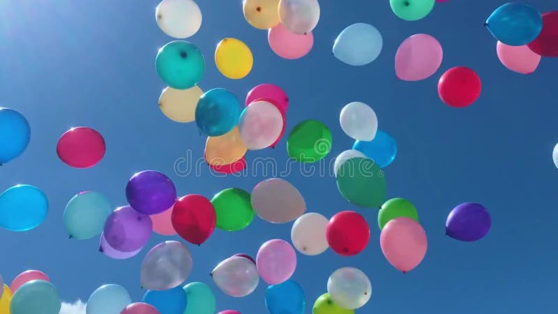 Many colorful balloons flying in the air