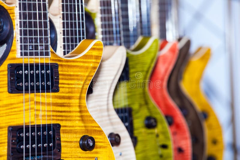 Many colorful guitars in musical shop