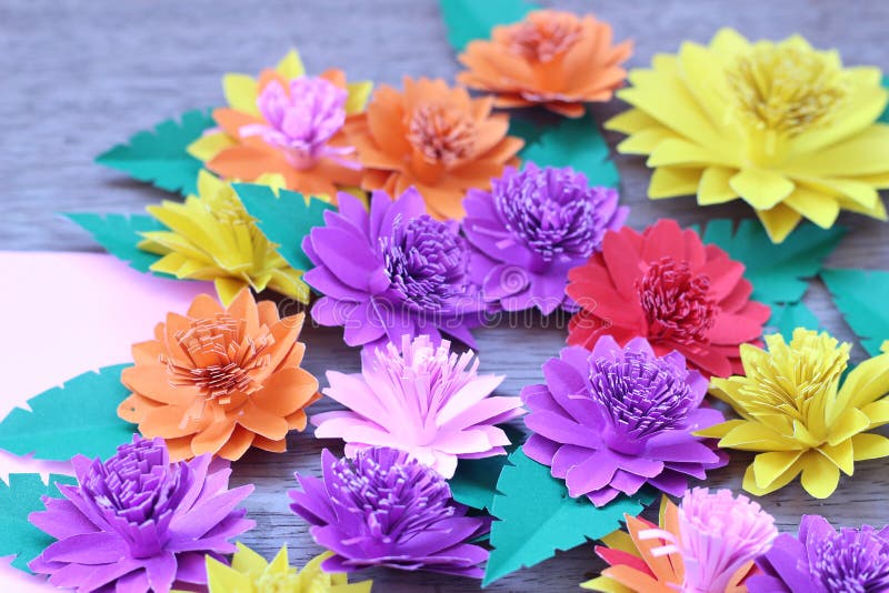 Many Colorful Paper Flowers On A Background With A Smooth Surface Stock