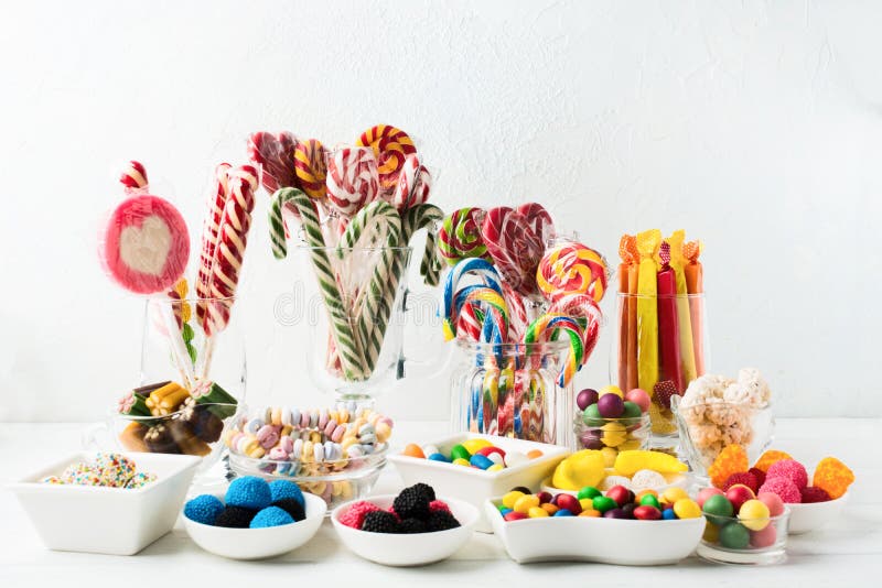 Many colorful unhealthy sweets - candy canes, jelly. Sweet mix desserts for Birthday, Christmas or Halloween. Sweets bar