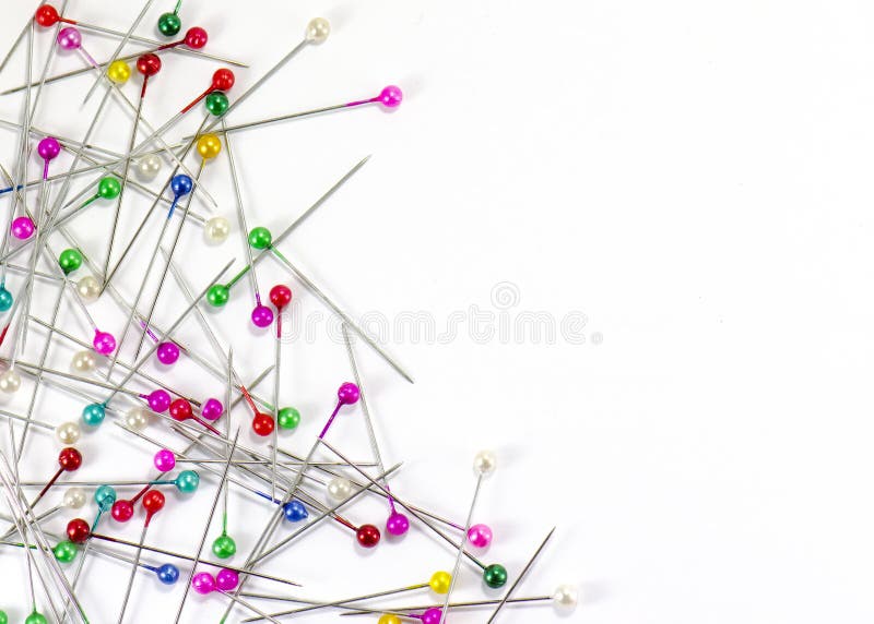 Heap of multi-coloured sewing pins on a white background, Stock image