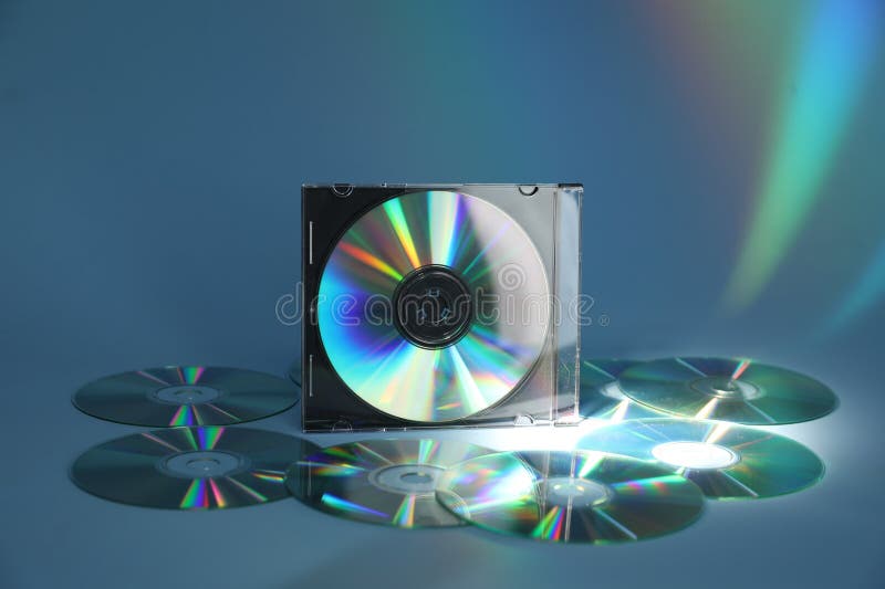 Many compact discs on light blue background royalty free stock photos