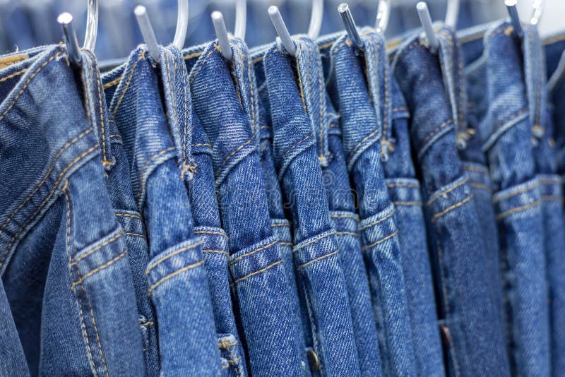 Many Denim Jeans Hanging on a Rack Stock Image Image of denim, male