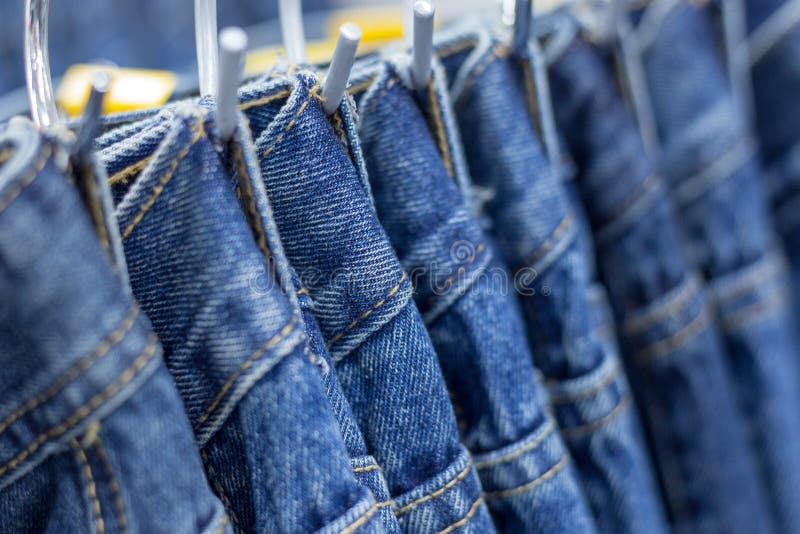 Many Denim Jeans Hanging on a Rack Stock Image Image of denim, male