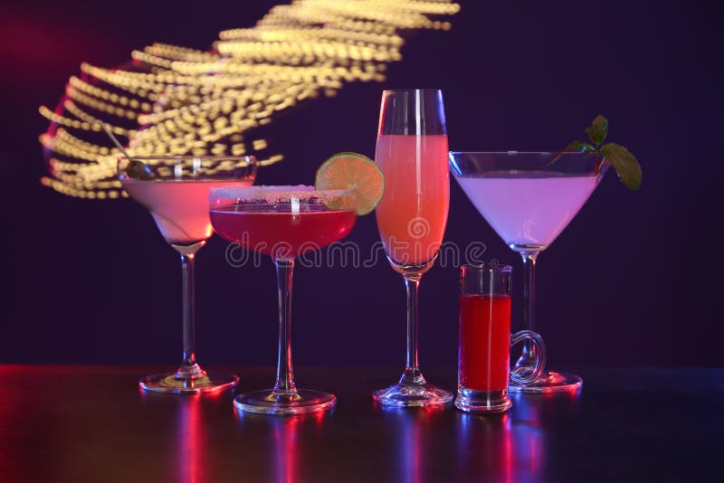 Many Different Alcoholic Drinks on Table Against Dark Background with