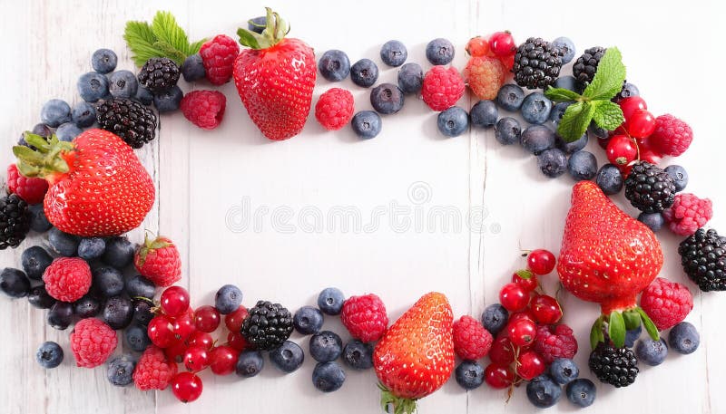 Many different berries in the form of a frame on a white background. royalty free illustration