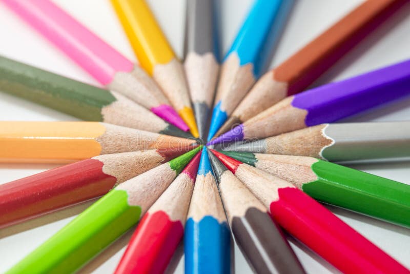 Many different colored pencils on white background. Color pencils in arrange in color wheel colors on white background