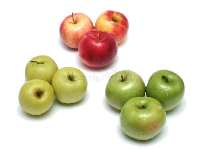 Many different ripe tasty apples on a white backgr