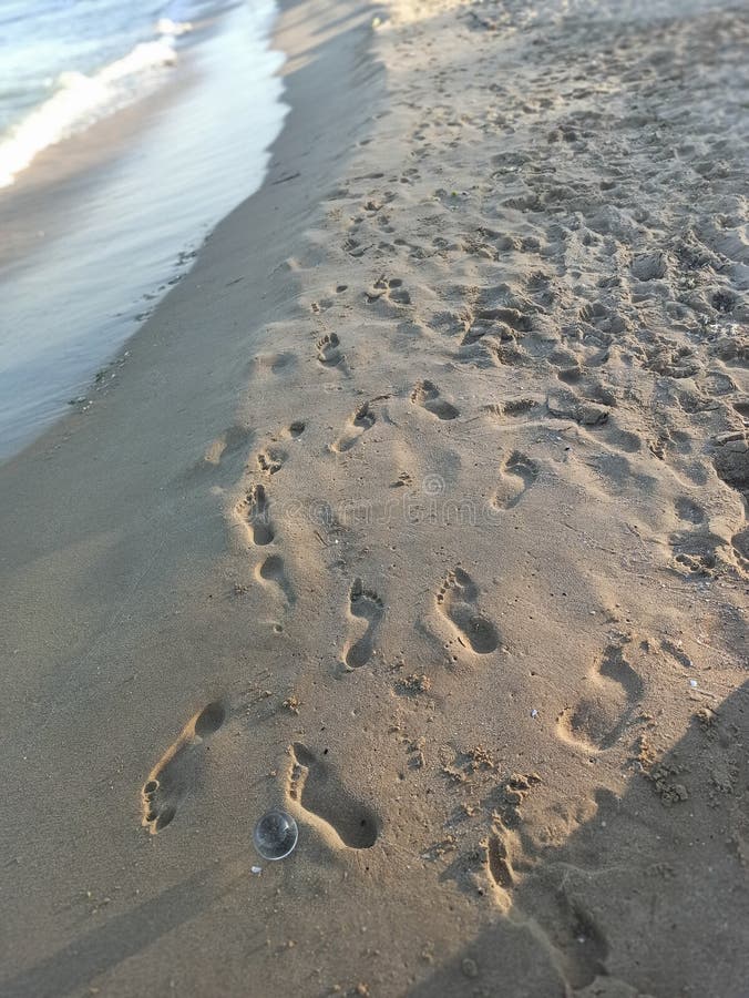 Many Footprints on the Beach Sand in Different Directions Stock Image ...