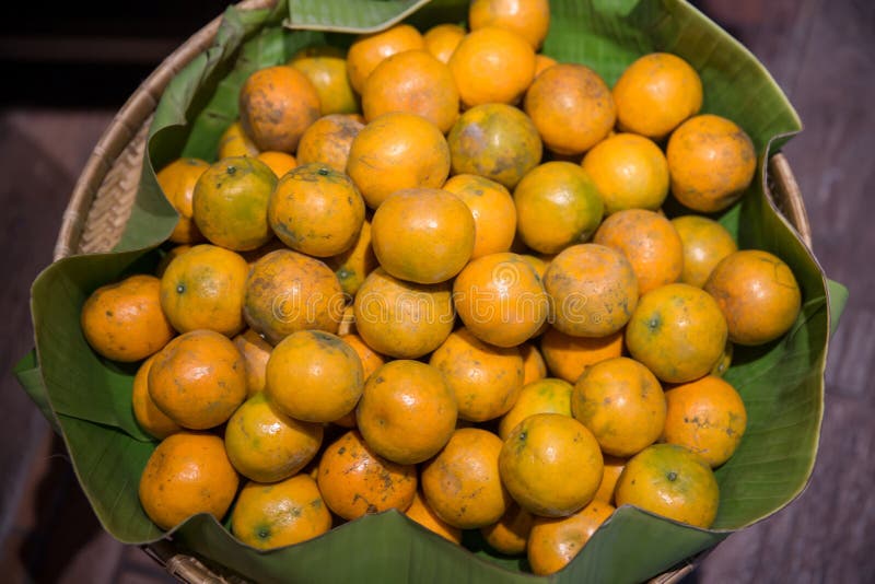 Many fresh and beautiful Oranges with a good taste in the basket at the market. Many orange put on shelves in the market. stock photos Many fresh and beautiful Oranges with a good taste in the basket at the market. Many orange put on shelves in the market. stock photos