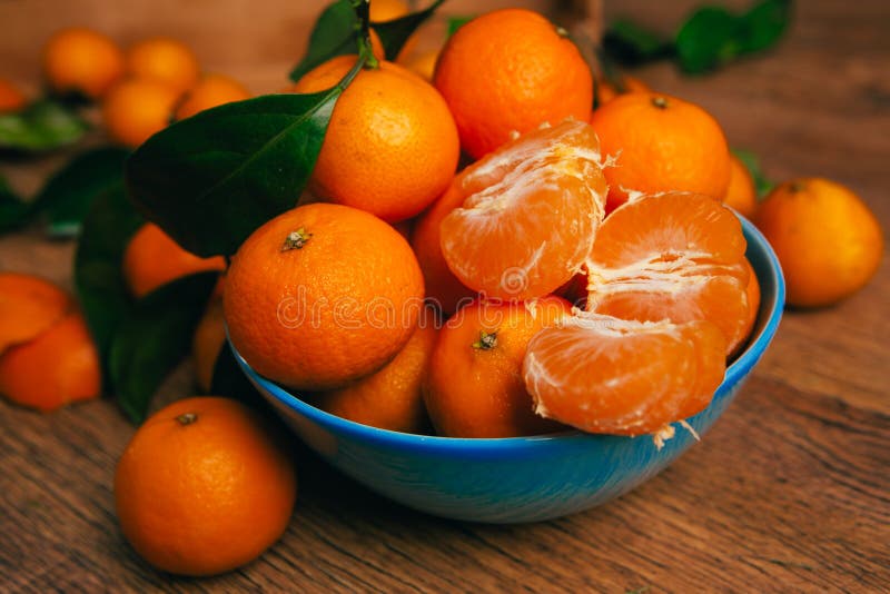 Many Fresh Mandarin Oranges in Blue Bowl, Standing on a Wooden Table Stock Image Image of