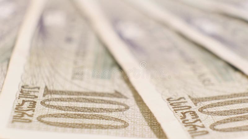 Many Georgian Banknotes of 100 Lari on Rotating Table. Closeup stock footage